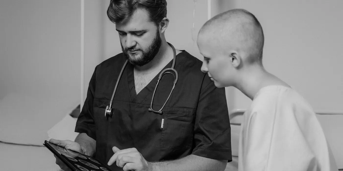 A doctor talking a patient through information on a tablet
