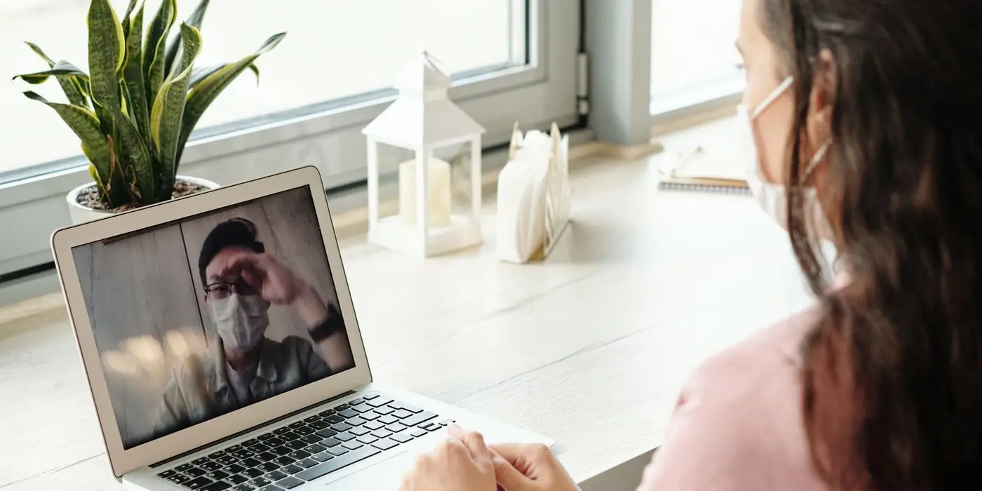 A patient on a video call with a doctor from home